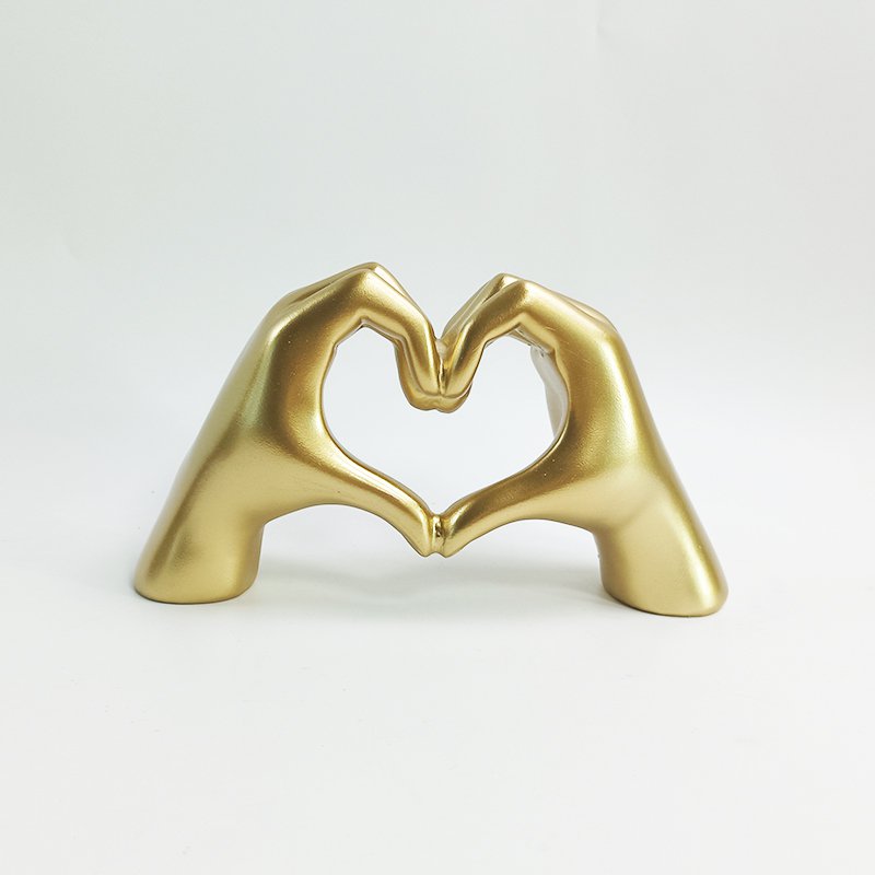 Polyresin hand hart goud